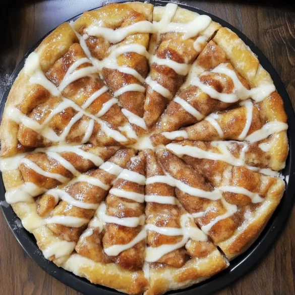 A warm Cinnamon-Sugar Pizza drizzled with icing, served on a wooden board.
